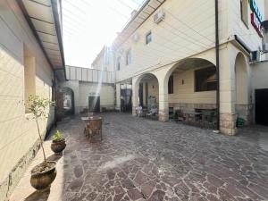 a hallway of a building with tables and potted plants at The green regency in Toshkent-Passajir Bekati