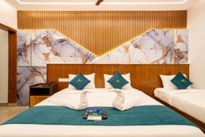 a bedroom with a bed with two towels on it at Daan Luxe Inn in Trivandrum