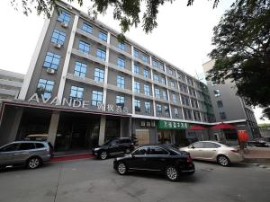 a large building with cars parked in front of it at Shenzhen Lavande Hotel Airport Terminal Branch in SZX