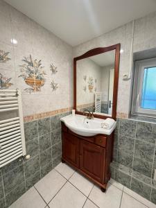 a bathroom with a sink and a mirror at L'escapade Beaujolaise in La Chapelle-de-Guinchay +29 photos