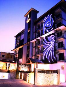 a building with a painting of a wave on it at Metro Hotel & Spa in Thung Song