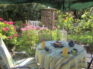 a blue table with a plate of food on it at Apartment Christine in Altena