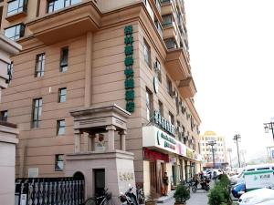 a building with a sign on the side of it at GreenTree Inn Datong YundinGYAyuan Express Hotel in Datong