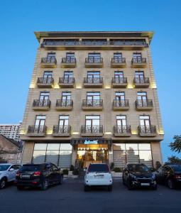 a building with cars parked in front of it at Boulevard Side Hotel in Baku