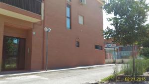 a red brick building with a street in front of it at Dimora Artigiani in Foggia
