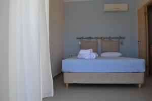 Postel nebo postele na pokoji v ubytování Edem Suites