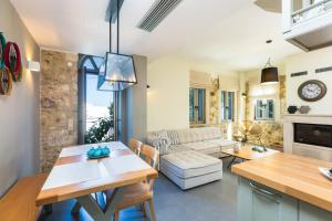 a kitchen and living room with a table and chairs at Philoxenia Residences in Panormos Rethymno