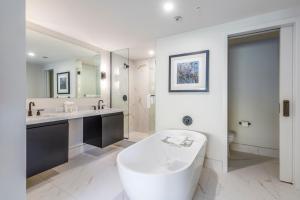 a bathroom with a large tub and a large mirror at Main & SKY by EXMAR in Park City