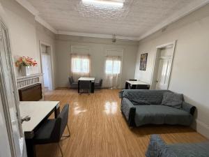 a living room with a couch and a table at Jerilderie Hotel in Jerilderie