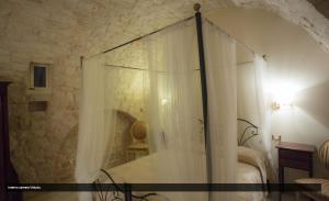 a bedroom with a bed with a curtain at La Dolce Vite in Turi