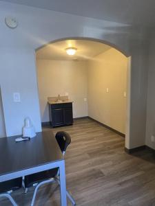 an empty room with a table and a sink at Cloud 9 Inn - El Ciello Inn in Pico Rivera