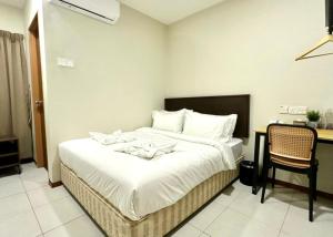 a bedroom with a bed with a desk and a chair at Swing & Pillows - Salak Tinggi KLIA Transit in Sepang +16 photos