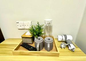 a table with a tray with items on it at Swing & Pillows - Salak Tinggi , KLIA 1 KLIA 2 in Sepang