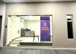 a chair sitting in a window of a hotel entrance at Swing & Pillows - Salak Tinggi , KLIA 1 KLIA 2 in Sepang