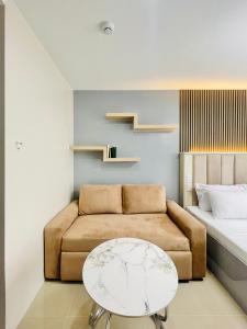 a living room with a couch and a table at Bernwood Tower in Iloilo City