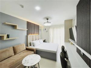 a small room with a bed and a couch at Bernwood Tower in Iloilo City +9 photos