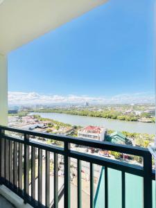 a view of a river from a balcony at Bernwood Tower in Iloilo City