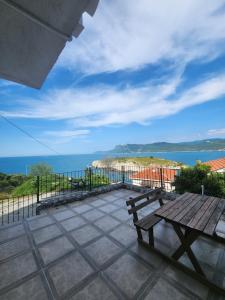 a bench sitting on a patio with a view of the ocean at Amasra Doğa Apart in Amasra