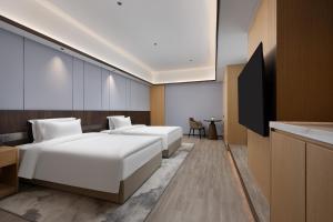 TV a/nebo společenská místnost v ubytování Wanda Moments Neo, Shijiazhuang Chang'an