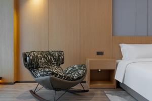 Postel nebo postele na pokoji v ubytování Wanda Moments Neo, Shijiazhuang Chang'an