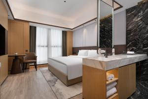 Postel nebo postele na pokoji v ubytování Wanda Moments Neo, Shijiazhuang Chang'an