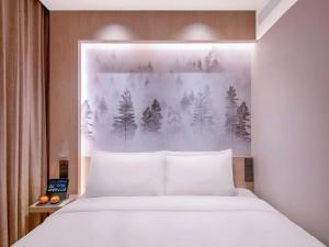 Ένα ή περισσότερα κρεβάτια σε δωμάτιο στο Orange Hotel Beijing Zhongguancun University of Science and Technology