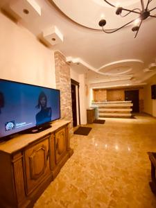 a large living room with a large flat screen tv at Luxurious Duplex, 5K Premium Housing! in Kafr al Ishārah +32 photos