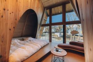 a bed in a room with a large window at SANU 2nd Home 山中湖1st in Yamanakako