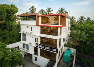 an apartment building with a sign that reads dean live inn at Daan Luxe Inn in Trivandrum
