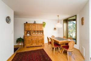 a kitchen with a table and chairs in a room at Chesa Aquileja Trüb in Pontresina