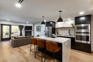 a kitchen and living room with a couch and a table at Main & SKY by EXMAR in Park City +16 photos