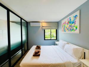 a bedroom with a white bed and a window at Comfy studio - 10 min walk to NaiYang Beach in Nai Yang Beach +22 photos