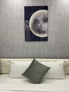 a white couch with a picture of the moon at Grand C Homestay in Hanoi +99 photos