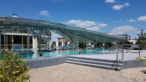 a swimming pool with people in the water at Crystal R31 Relax in Sárvár