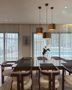 a dining room with a glass table and chairs at Hatta Valley Lodge in Hatta +70 photos