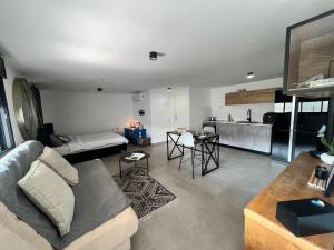 a living room with a couch and a kitchen at הסטודיו in Beer Sheva +14 photos