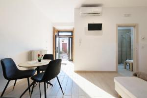 een woonkamer met een tafel en stoelen bij Cantine Cippone Room in Monte SantʼAngelo