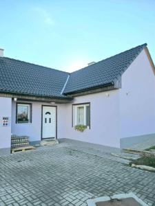 a white house with a tile roof at U Richtára in Klokoč