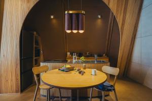 a kitchen with a table with chairs and a sink at SANU 2nd Home 八ヶ岳2nd in Hokuto