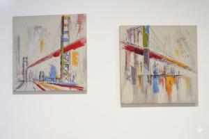 two pieces of art on a white wall at La Terrazza di Andrea in Imperia