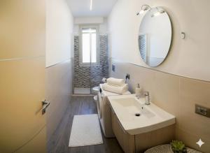 a bathroom with a sink and a mirror at La Terrazza di Andrea in Imperia +6 photos
