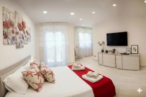 a bedroom with a large bed with a red blanket at La Terrazza di Andrea in Imperia