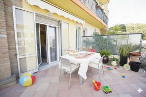 a patio with a white table and chairs at La Terrazza di Andrea in Imperia