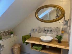 a bathroom with a sink and a mirror at Gasthaus Hecker Hof in Bad Salzungen +31 photos
