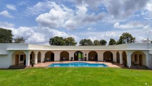an exterior view of a building with a swimming pool at Serene Kabini Wild lodge in Kabini River