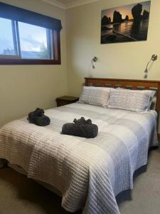 a bedroom with a bed with two towels on it at Whispering Pines in Kaihinu