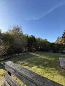 a park with a bench and a field of grass at Whispering Pines in Kaihinu