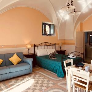 a bedroom with a bed and a couch and a table at Villa Raffaella in Santa Cesarea Terme +125 photos