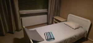 a bedroom with a white bed and a window at Pankkikallio in Sorsakoski +8 photos