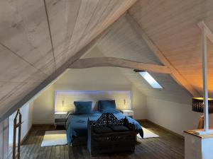 a bedroom with a bed in the attic at Jardin de l'ardoiserie in Saint-Gravé